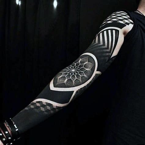 A Man With A Black And White Tattoo On His Arm