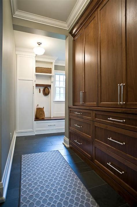Slide the side panels of the storage cabinet into place so they sit snugly between the top and bottom panels and are flush with the wall on either side of the. Floor to Ceiling Brown Stained Mudroom Cabinets ...