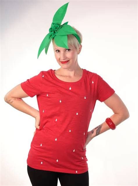 A Woman Wearing A Red Shirt With A Green Bow On Her Head And Black Leggings
