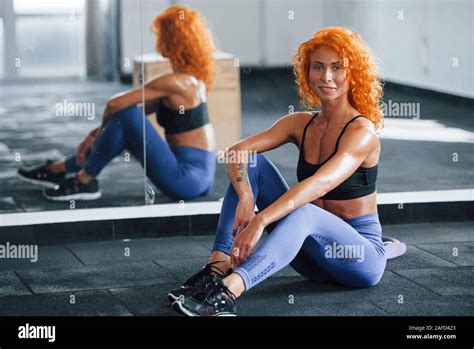 Sitting And Taking A Break Sporty Redhead Girl Have Fitness Day In Gym At Daytime Muscular
