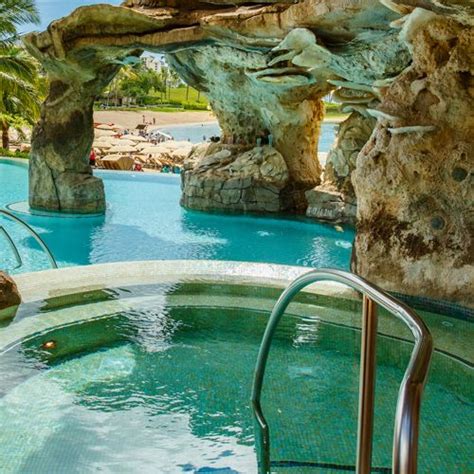 Display Larger Version Of A Rocky Outcropping Surrounds A Hot Tub That