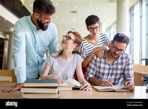 Happy University Students Studying With Books In Library Group Of