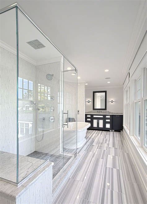 Free standing tub with wainscoting accentuate the stone. Glass enclosed shower next to free standing tub with ...