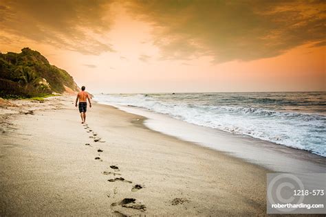 Man Walking On The Beach Stock Photo