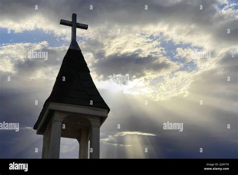 a rural chapel steeple heavenly sky sunbeams church symbol worship pray