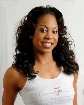 A Woman In White Tank Top Smiling At The Camera