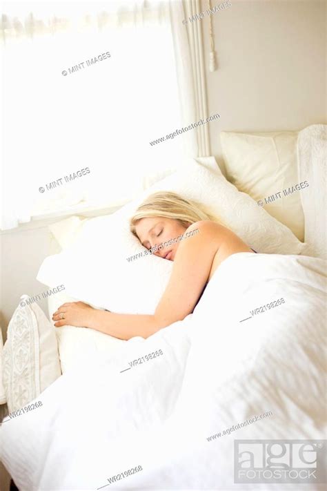 Blonde Woman Sleeping In A Bed With White Linen Stock Photo Picture
