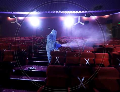 Image Of A Worker Sanitises Inside A Theatre Hall Ahead Of The