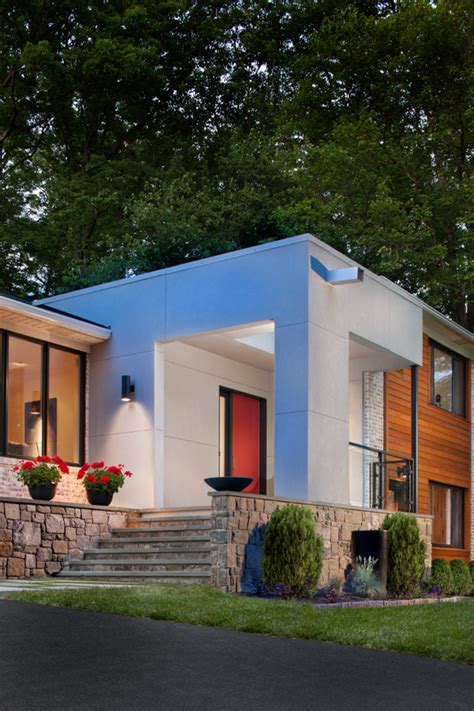 Exterior split level home with painted brick mid century modern vibe benjamin moore ballet white and orange and brown before after this mid century modern house in los angeles received a complete renovation. Modern Facade, New Entry and Garage Addition | Architect ...
