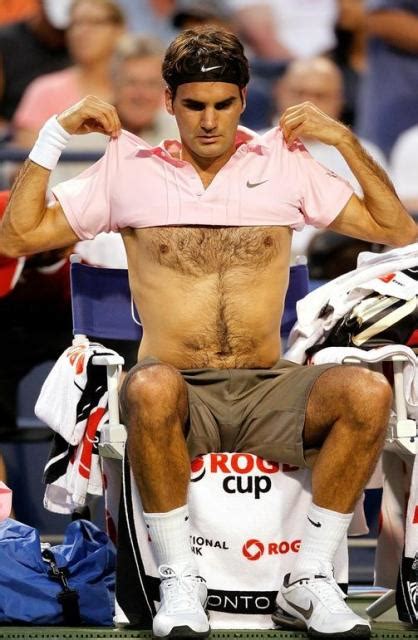 Roger Federer shows his bare chest as he removes his tennis shirt.JPG