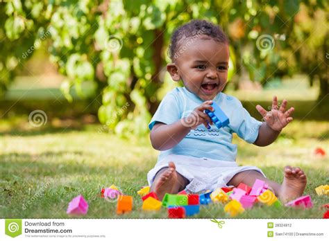 Little African American Baby Boy Playing In The Grass