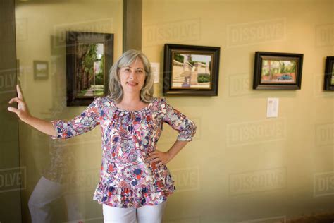 Caucasian Woman Leaning On Doorway Stock Photo Dissolve