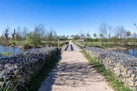 Straight Dirt Path Between Stone Fences In The Direction Of A