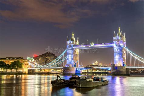 The Tower Bridge At Night With Boats On Thames River London Stock