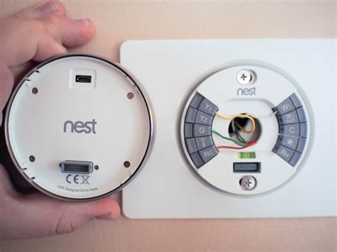 Thread the wires through the new thermostat's base and attach it to the wall. What you need to know about installing your Nest Thermostat | Android Central