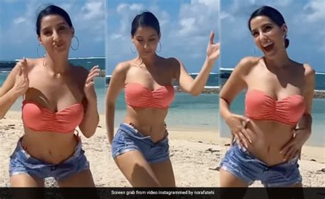 nora fatehi s dance moves only get stylishly better by the beach in a pink swim set denim shorts