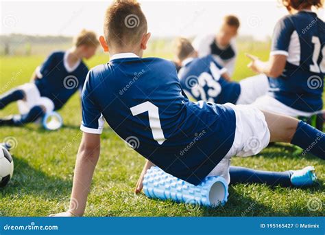 School Soccer Stretching Session Young Footballers Using Foam Rollers