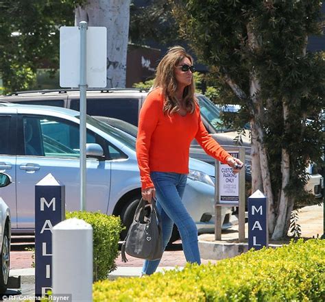 Caitlyn Jenner Wears An Orange Sweater And Cropped Skinny Jeans In