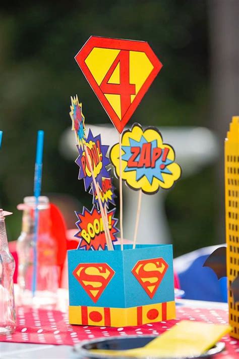 The Table Is Set Up For A Birthday Party With Superman Decorations And