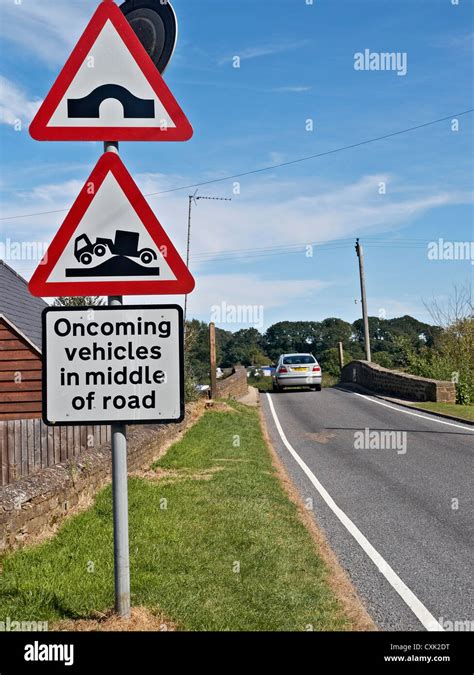 Uk Road Sign Warning Of The Danger Of Oncoming Vehicles In The Middle