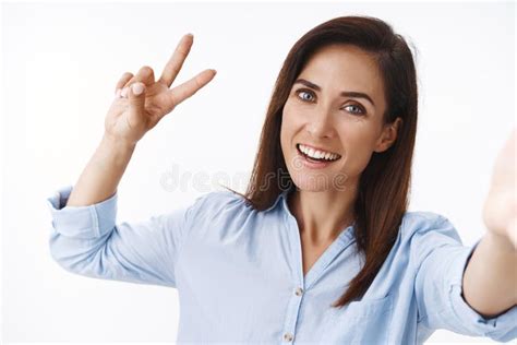 Cheerful Carefree Adult Caucasian Female 30s Woman Extend Arm Hold Camera Hand Show Peace