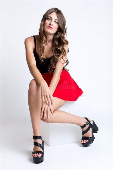 Fashionable Brunette Woman With Long Slim Legs Posing In Studio Stock