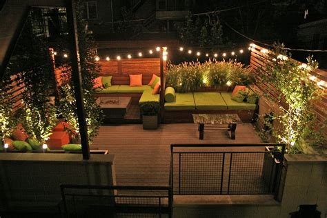 A Garden Rooftop Patio All Lit Up At Night By String Lights The Patio