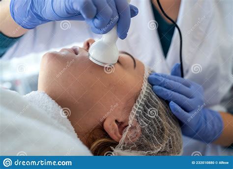 Cosmetologist Using Ultrasound Cavitation Machine Doing Procedure