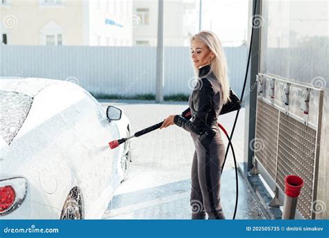 beautiful blonde woman washes white car at car wash stock image image of hose caucasian