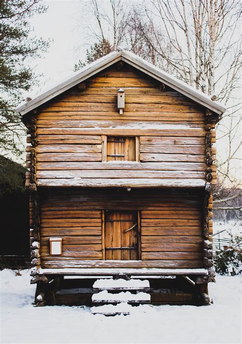 Brown Wooden House During Winter Season Photo Free Cabin Image On