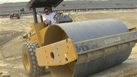 Roller Compactor And Bulldozer Working On Embankment For Highway From