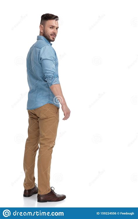 Casual Man Standing And Looking Back Over Shoulder Cool Stock Photo