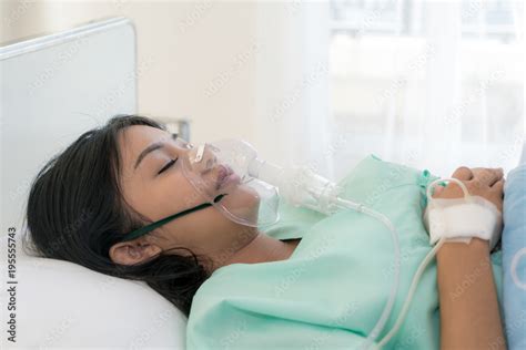 Asian Babe Woman Patient Receiving Oxygen Mask Lying On A Hospital Bed Stock Photo Adobe Stock