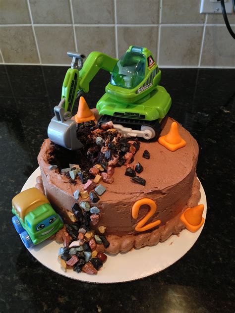 2 year olds love to play. Construction truck cake for 2 year old boy. Truck themed party. Chocolate cake with chocolate ...