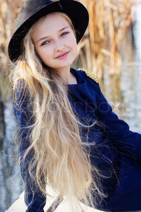 Teen girl with pretty face and long blonde hair. Little cute pretty girl with blonde ... | Stock Photo ...