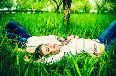 two happy pretty girls lying on the green grass stock image image of meadow embroidery 55082085