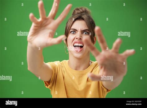 Funny Emotive Woman Making Fun Face Pulling Hands Forward To Attack Of