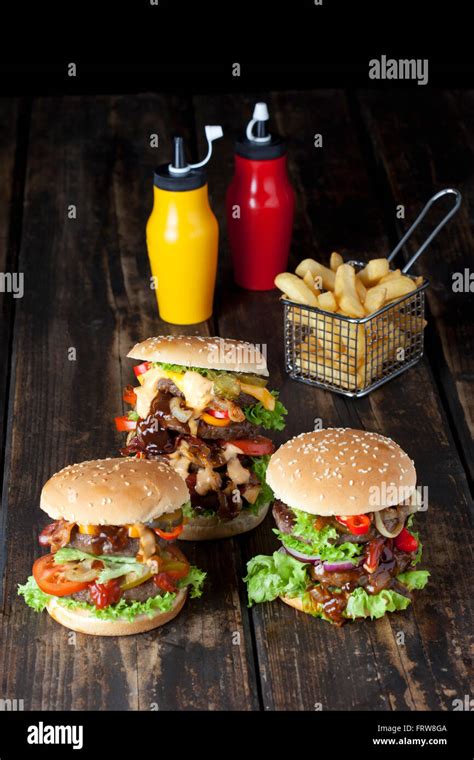 Large Hamburger With Fries And Ketchup And Mustard In Bottles Stock