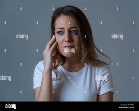 Close Up Portrait Of Beautiful Young Woman With Sad Mood Looking
