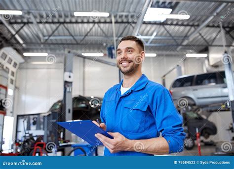 Happy Mechanic Man With Clipboard At Car Workshop Stock Photo Image