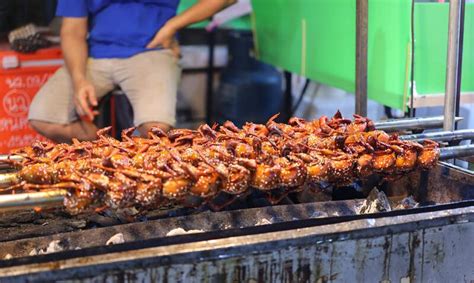 A Shop Selling Grilled Quail Marinated In Sauce A Popular Street Food