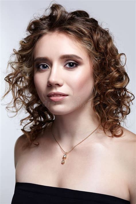 Beauty Portrait Of Young Woman With Curly Hair On Gray Background Stock