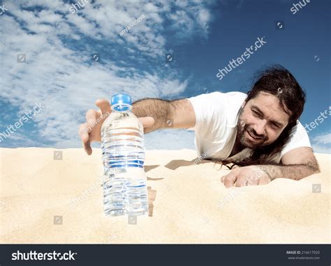 Thirsty Man In The Desert Reaches For A Bottle Of Water Toned Image