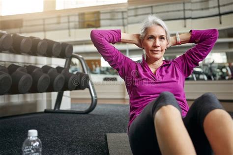Exercising Holds A Lot Of Transformative Power A Mature Woman Working Out At The Gym Stock