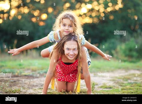 Two Cute Little Girls Playing And Laughing At The Countryside Happy