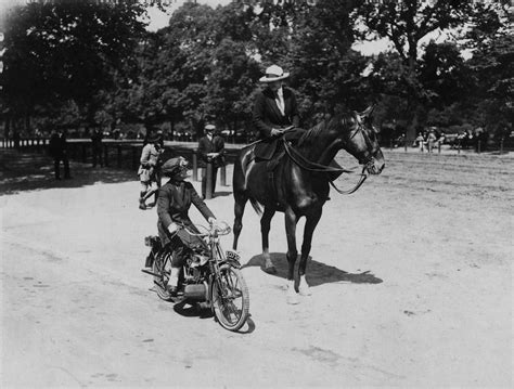 June 1921 A Woman Riding A Horse Alongside A Woman On A Motorcycle In