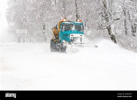 Snow Plow Truck Cleaning Snowy Road In Snowstorm Snowfall On The