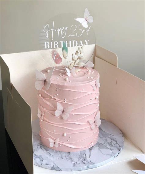 A Pink Birthday Cake With Butterflies On It
