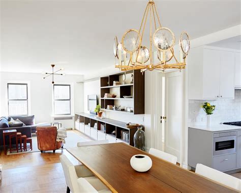 Unique Gold Chandelier Over Long Thin Table In Midcentury Modern