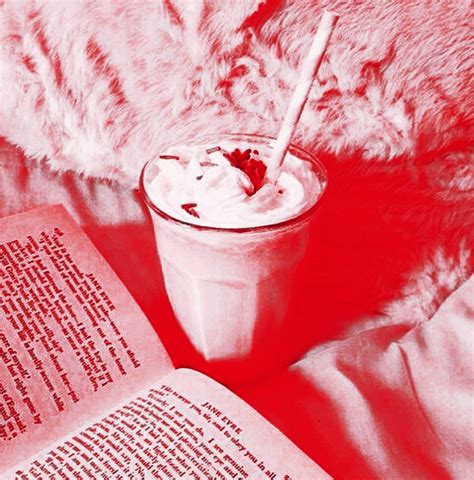 An Open Book And A Drink On A Bed